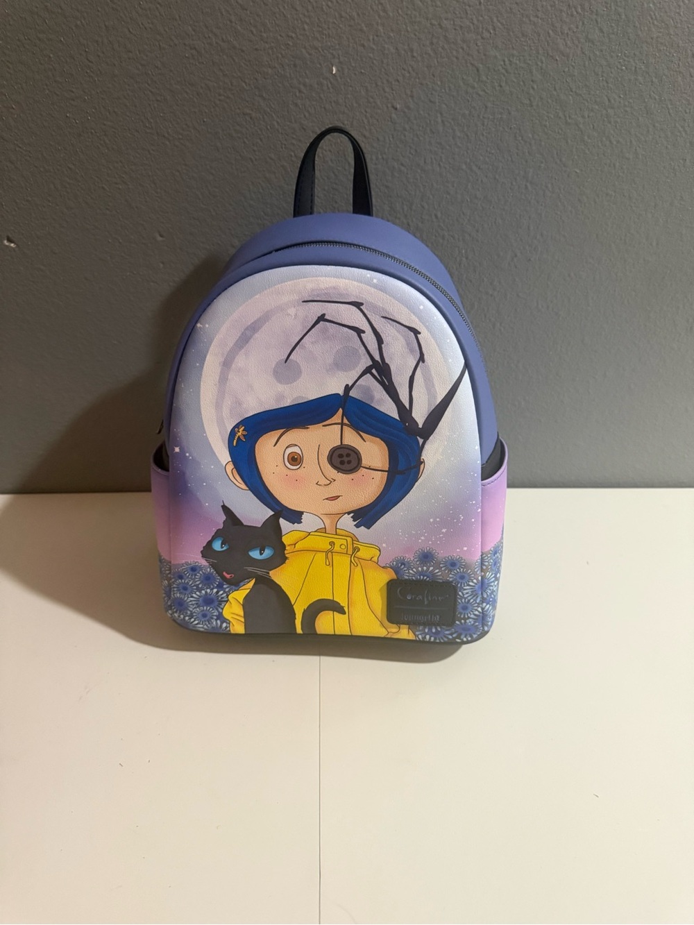 Loungefly Coraline Split Face Iridescent Mini Backpack.